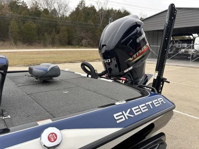 Slide: The Image of 2021 Skeeter FXR21 Limited boat with Yamaha VMAX engine, parked outdoors. - 13