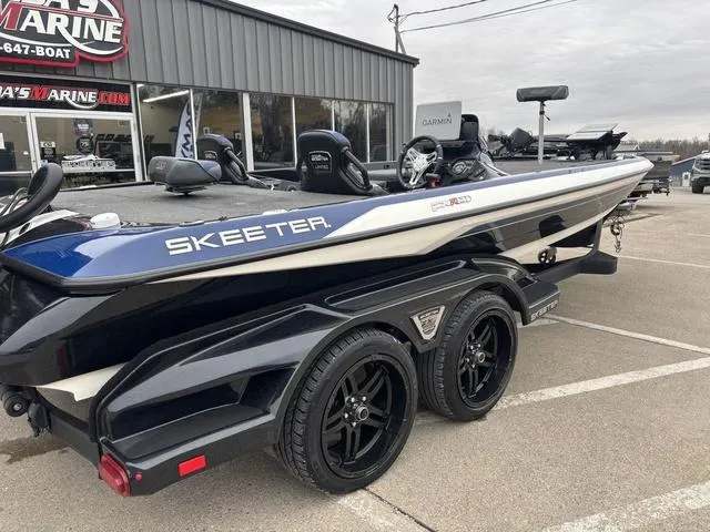 Slide: The Image of 2021 Skeeter FXR21 Limited boat on trailer outside marine dealership. - 5