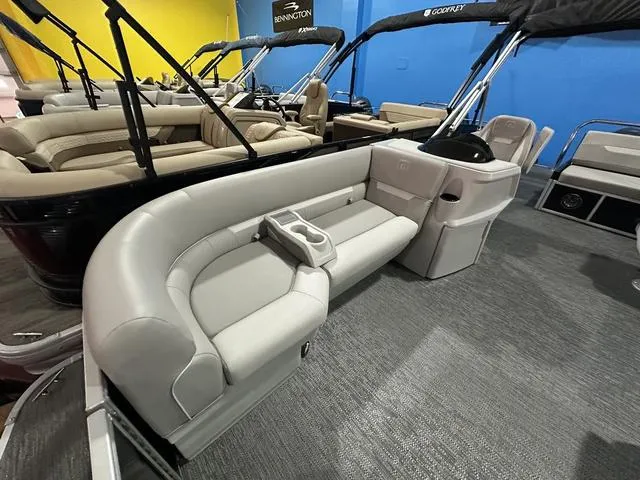 Slide: The Image of 2025 Godfrey Pontoons Xperience 2286 SFLX dashboard with steering wheel and seating area. - 4