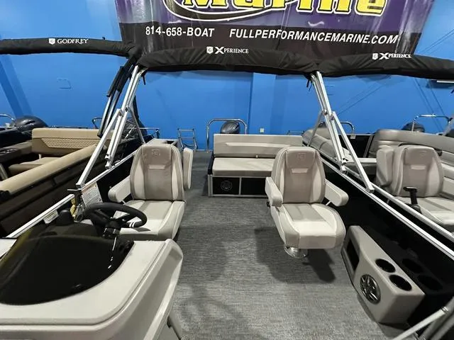 Slide: The Image of 2025 Godfrey Pontoons Xperience 2286 SFLX with seating and outboard motor, docked outdoors. - 5