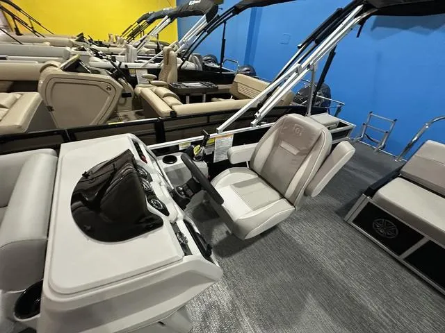 Slide: The Image of 2025 Godfrey Pontoons Xperience 2286 SFLX interior with beige seating and steering console. - 8
