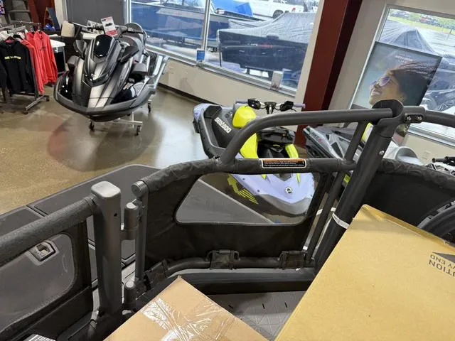 Slide: The Image of 2025 Sea-Doo Switch™ Fish 21 - 230 hp in showroom, alongside other watercraft. - 8