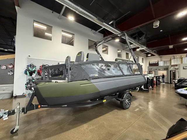 Slide: The Image of 2025 Sea-Doo Switch™ Fish 21 - 230 hp boat displayed at an indoor exhibition. - 1