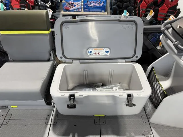Slide: The Image of 2025 Sea-Doo Switch Fish 21 storage compartment with open lid, showcasing interior space. - 16