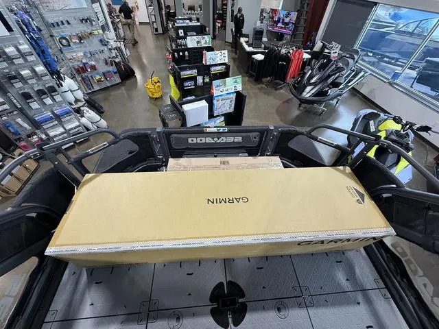 Slide: The Image of 2025 Sea-Doo Switch™ Fish 21 with Garmin box in a showroom setting. - 24