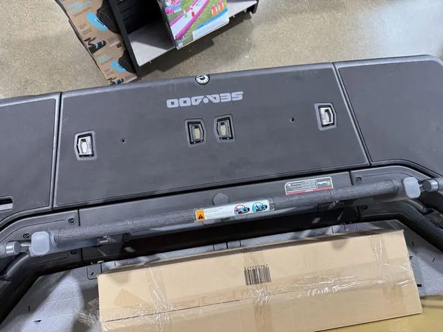 Slide: The Image of 2025 Sea-Doo Switch™ Fish 21 - 230 hp Painted, rear view with cardboard box. - 26