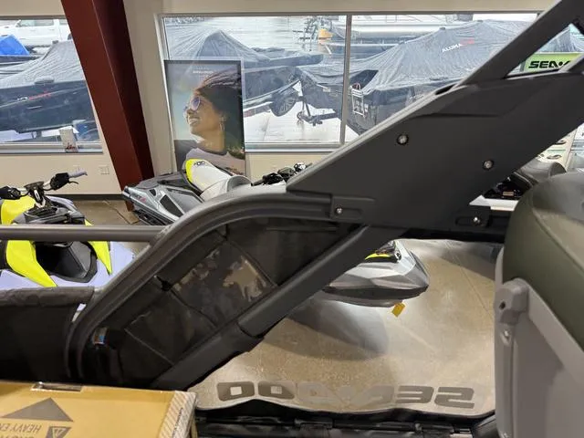 Slide: The Image of 2025 Sea-Doo Switch™ Fish 21 - 230 hp Painted, showroom display with watercraft in background. - 9