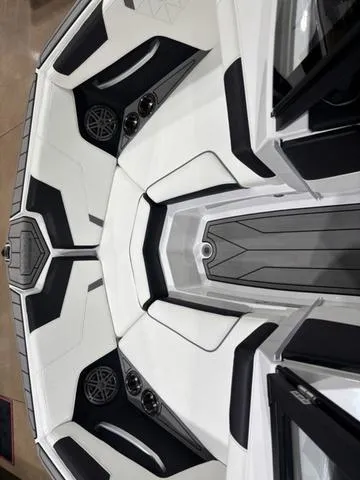 Slide: The Image of 2025 Nautique Super Air Nautique GS20 boat interior with sleek black and white design. - 14