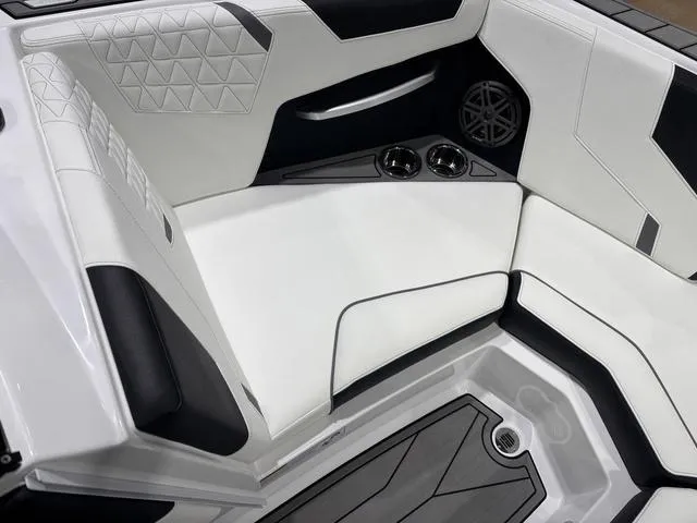 Slide: The Image of 2025 Nautique Super Air Nautique GS20 interior with white leather seats and cup holders. - 15