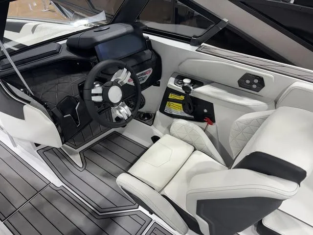 Slide: The Image of 2025 Nautique Super Air Nautique GS20 cockpit with modern steering and luxurious seating. - 19