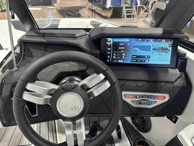 Slide: The Image of 2025 Nautique Super Air Nautique GS20 dashboard with touchscreen and steering wheel. - 21