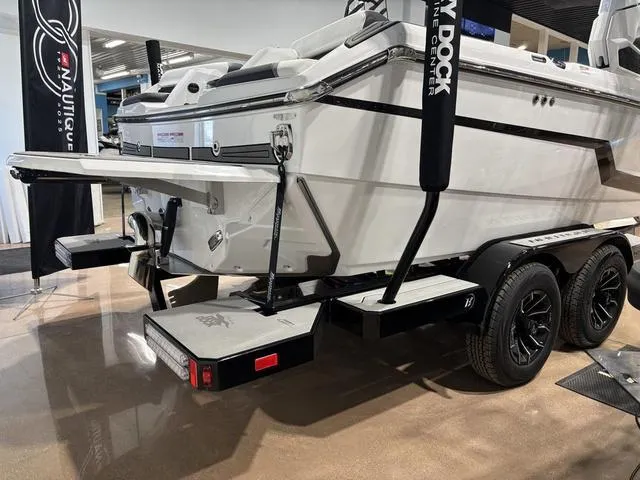 Slide: The Image of 2025 Nautique Super Air Nautique GS20 boat on trailer, rear view in showroom. - 5