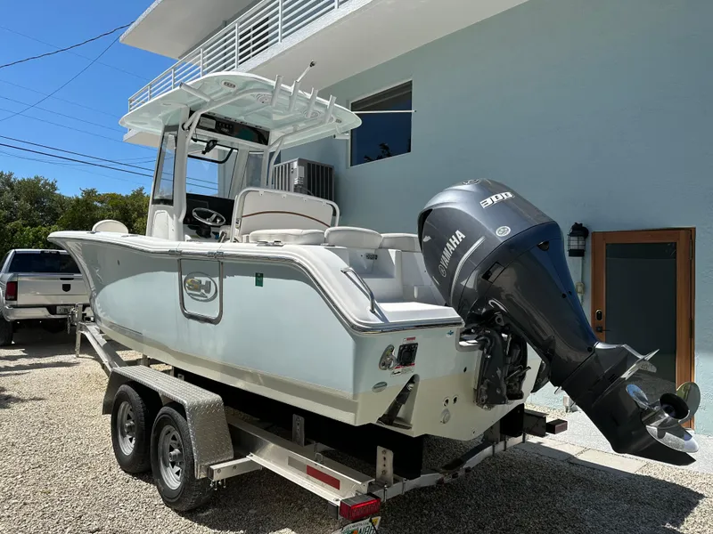 Slide: The Image of 2019 Sea Hunt Ultra 255 SE boat on trailer with Yamaha outboard motor. - 0