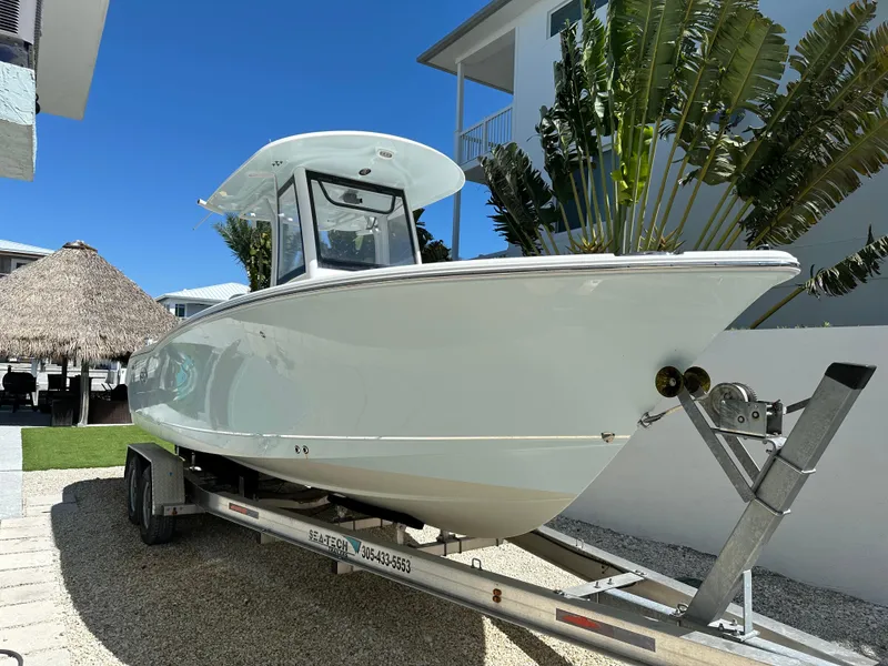 Slide: The Image of 2019 Sea Hunt Ultra 255 SE boat on trailer, parked outdoors. - 1