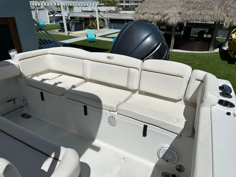 Slide: The Image of 2019 Sea Hunt Ultra 255 SE boat with spacious white seating area. - 10