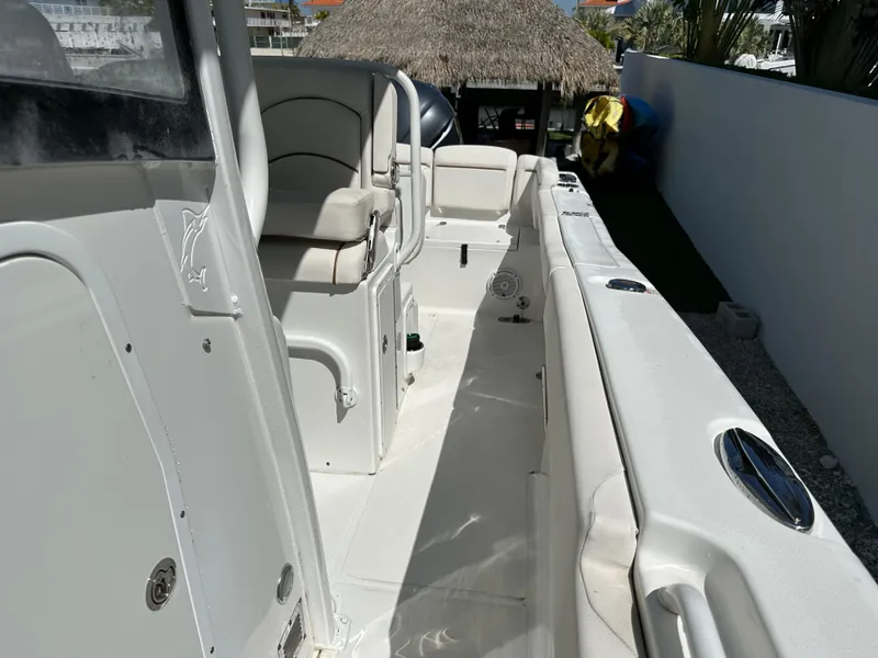 Slide: The Image of 2019 Sea Hunt Ultra 255 SE boat interior, featuring seating and deck layout. - 12