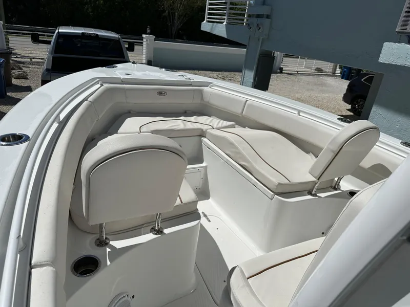 Slide: The Image of 2019 Sea Hunt Ultra 255 SE boat interior with white seating and cup holders. - 13