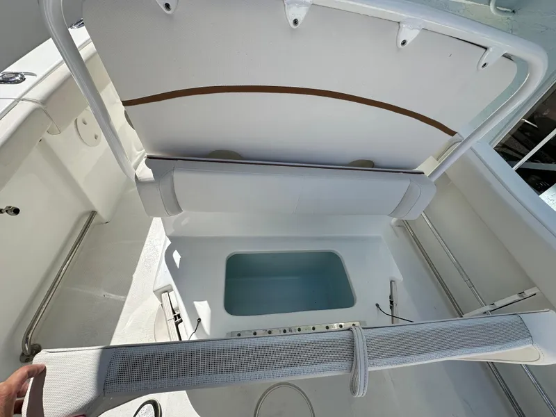 Slide: The Image of 2019 Sea Hunt Ultra 255 SE boat interior with open storage compartment. - 5