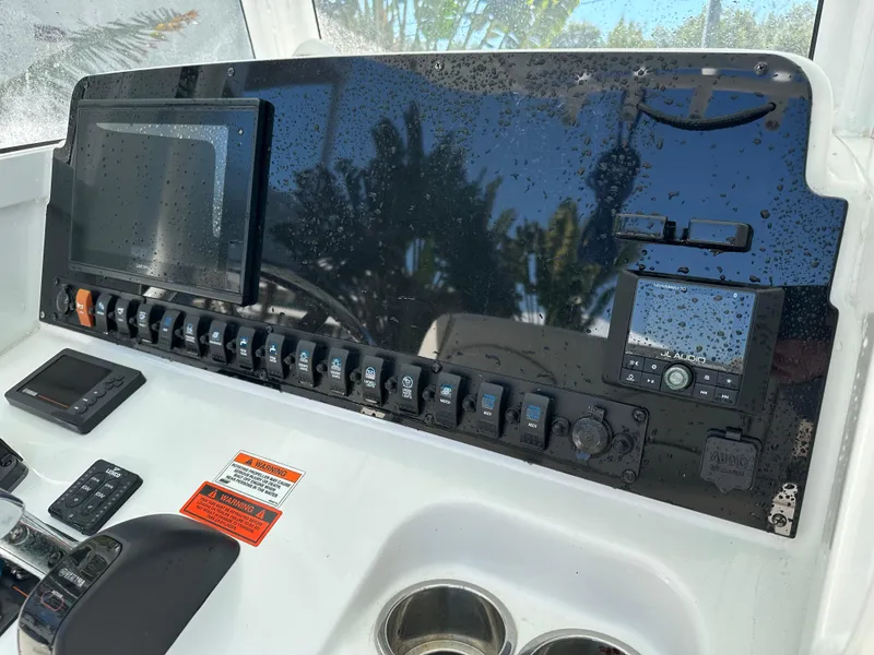Slide: The Image of Control panel of 2019 Sea Hunt Ultra 255 SE boat with electronic displays and switches. - 6