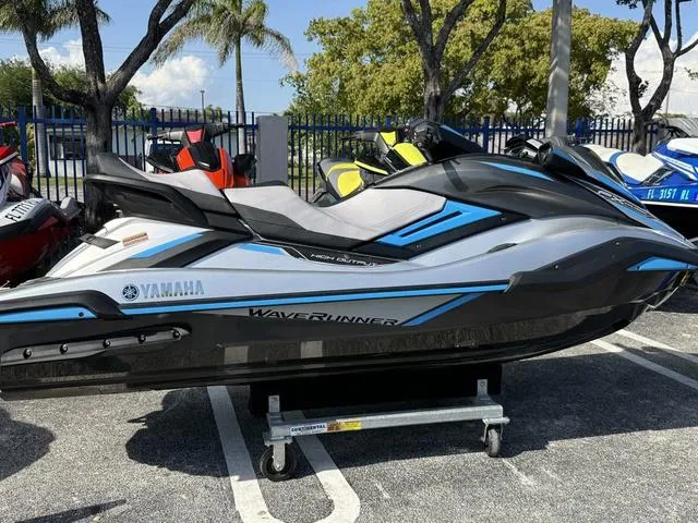 Slide: The Image of 2020 Yamaha WaveRunner FX Cruiser HO in a parking lot, surrounded by trees and other watercraft. - 3