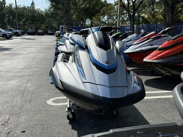 Slide: The Image of 2020 Yamaha WaveRunner FX Cruiser HO in a parking lot, surrounded by trees and other watercraft. - 6