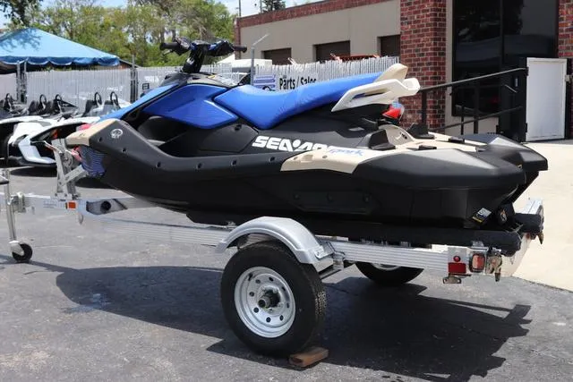 Slide: The Image of 2025 Sea-Doo Waverunner PWC SPARK TRIXX 90 on trailer, parked outdoors. - 4