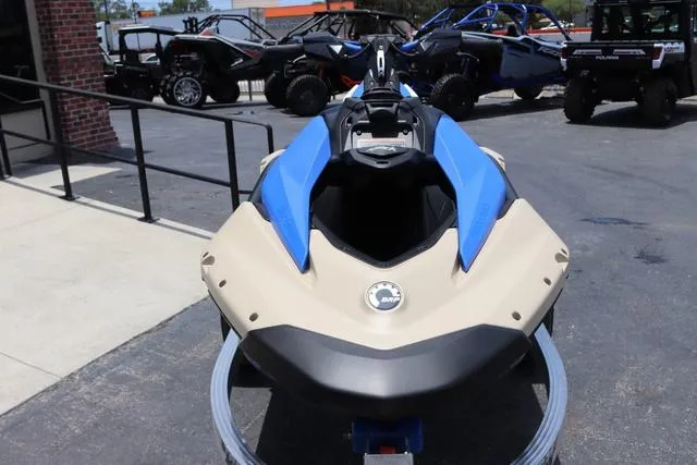 Slide: The Image of 2025 Sea-Doo Waverunner PWC SPARK TRIXX 90 in blue and beige, parked outdoors. - 9