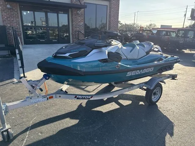 Slide: The Image of 2025 Sea-Doo Waverunner PWC GTX LTD on trailer, parked outside a building. - 2