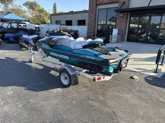 Slide: The Image of 2025 Sea-Doo Waverunner GTX LTD on trailer, parked outside a building. - 3