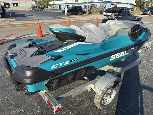 Slide: The Image of 2025 Sea-Doo Waverunner GTX LTD 325 on trailer, vibrant teal color, parked outdoors. - 6