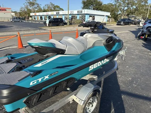 Slide: The Image of 2025 Sea-Doo Waverunner GTX LTD on trailer, parked outdoors in a lot. - 7