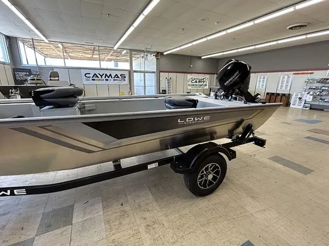Slide: The Image of 2025 Lowe Skorpion SS boat on display in a showroom with trailer. - 4