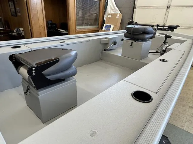 Slide: The Image of 2025 Lowe Skorpion SS boat interior with two cushioned seats and fishing rod holders. - 5