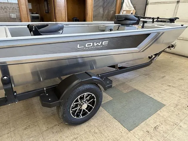 Slide: The Image of 2025 Lowe Skorpion SS boat on trailer, sleek design, metallic finish, indoor setting. - 6