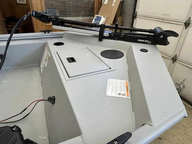 Slide: The Image of 2025 Lowe Skorpion SS boat with Minn Kota trolling motor in a garage setting. - 7
