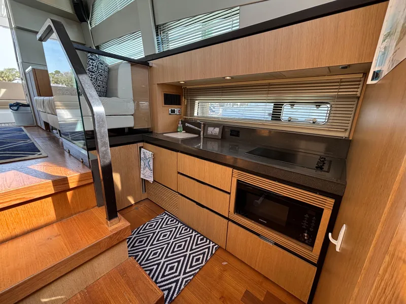 Slide: The Image of Modern kitchen interior of 2015 Fairline Squadron 42 yacht with wood cabinetry and appliances. - 16