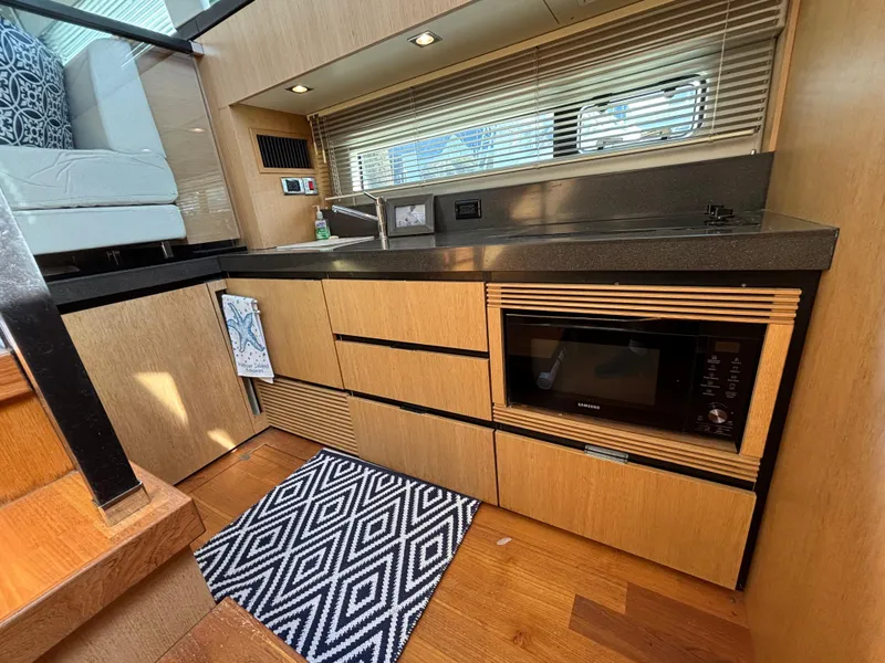 Slide: The Image of Modern kitchen interior of 2015 Fairline Squadron 42 yacht with wood cabinetry and appliances. - 18