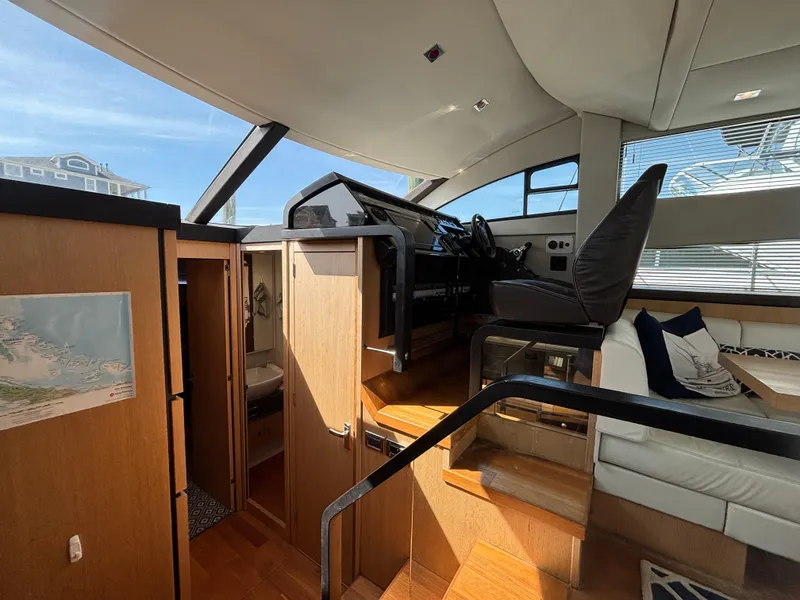 Slide: The Image of Interior of 2015 Fairline Squadron 42 yacht, featuring helm and seating area. - 20