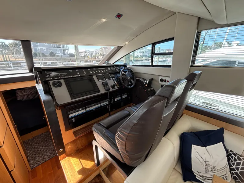 Slide: The Image of Interior helm of 2015 Fairline Squadron 42 yacht, featuring modern controls and leather seating. - 23