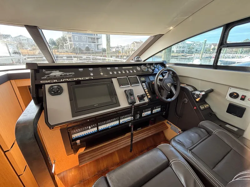 Slide: The Image of 2015 Fairline Squadron 42 yacht helm with modern controls and leather seating. - 27