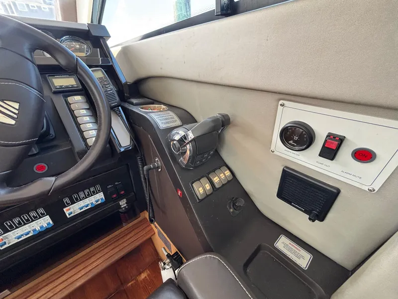 Slide: The Image of Control panel of a 2015 Fairline Squadron 42 yacht, featuring steering wheel and switches. - 29