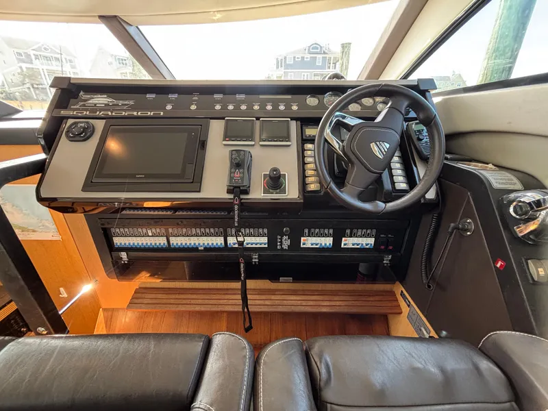 Slide: The Image of 2015 Fairline Squadron 42 yacht helm with steering wheel and control panel. - 30