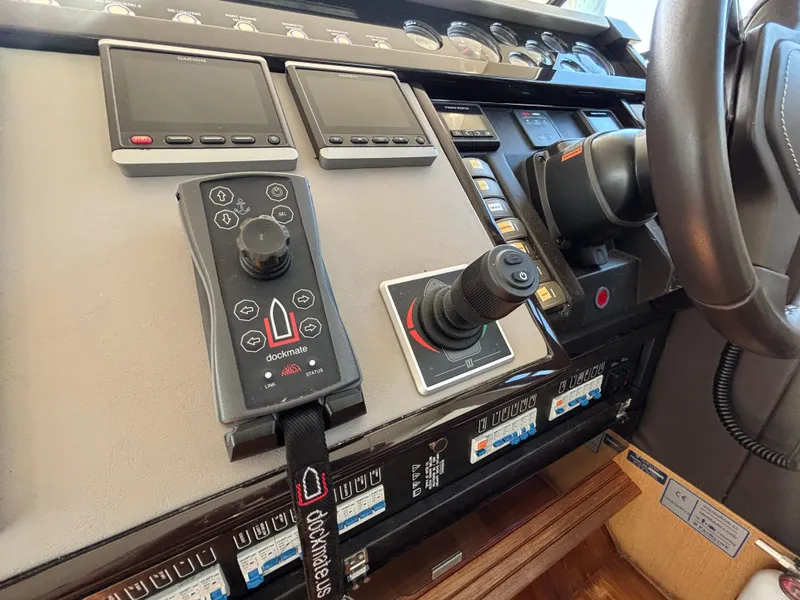 Slide: The Image of Control panel of 2015 Fairline Squadron 42 yacht with navigation screens and joystick. - 32