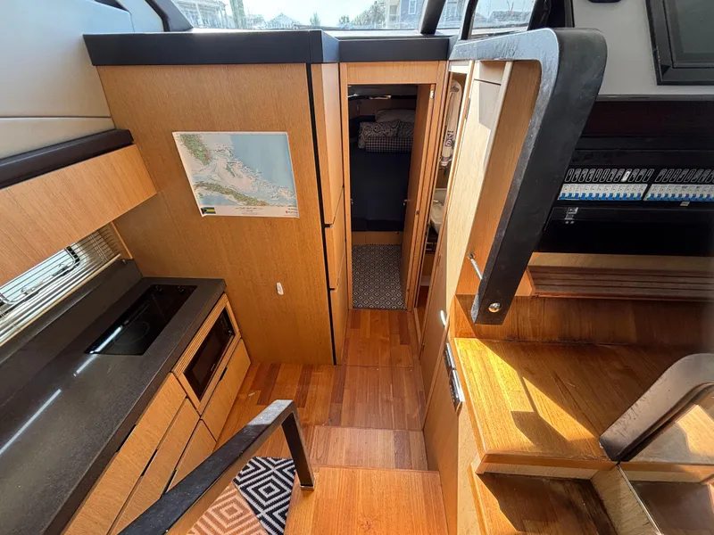 Slide: The Image of Interior of 2015 Fairline Squadron 42 yacht, featuring modern kitchen and wooden flooring. - 34