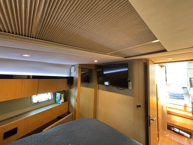 Slide: The Image of Interior of 2015 Fairline Squadron 42 yacht, featuring a cozy bedroom with modern amenities. - 39