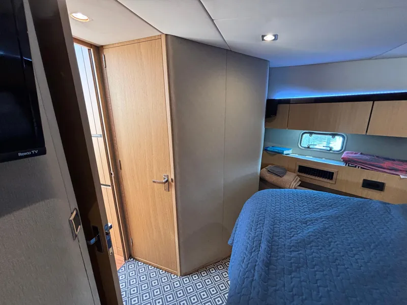 Slide: The Image of Interior cabin of 2015 Fairline Squadron 42 yacht, featuring cozy bed and wooden decor. - 41