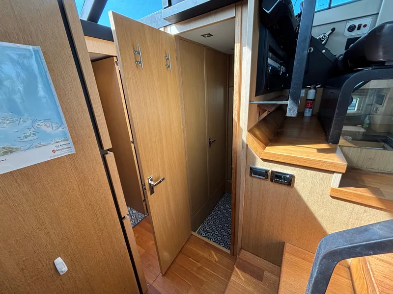 Slide: The Image of Interior of 2015 Fairline Squadron 42 yacht, featuring wooden cabinetry and modern design elements. - 47
