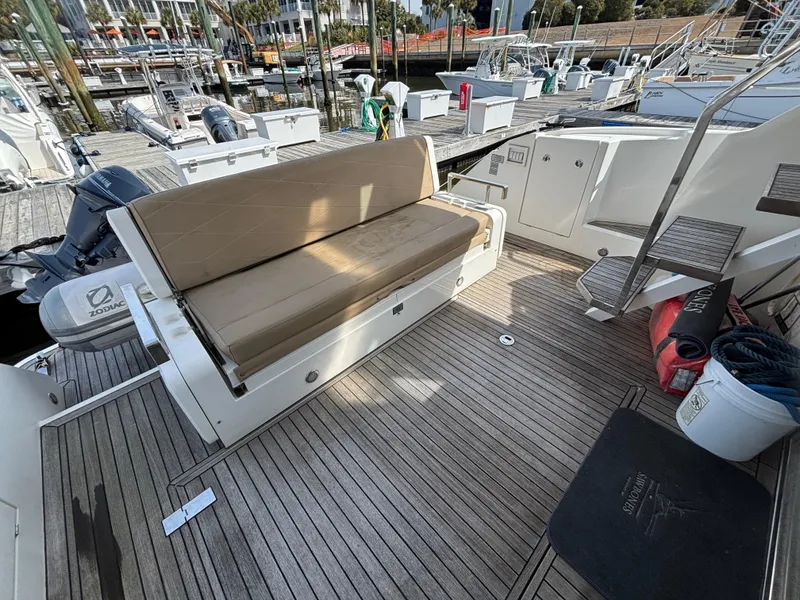 Slide: The Image of 2015 Fairline Squadron 42 yacht deck with seating and storage, docked at marina. - 5