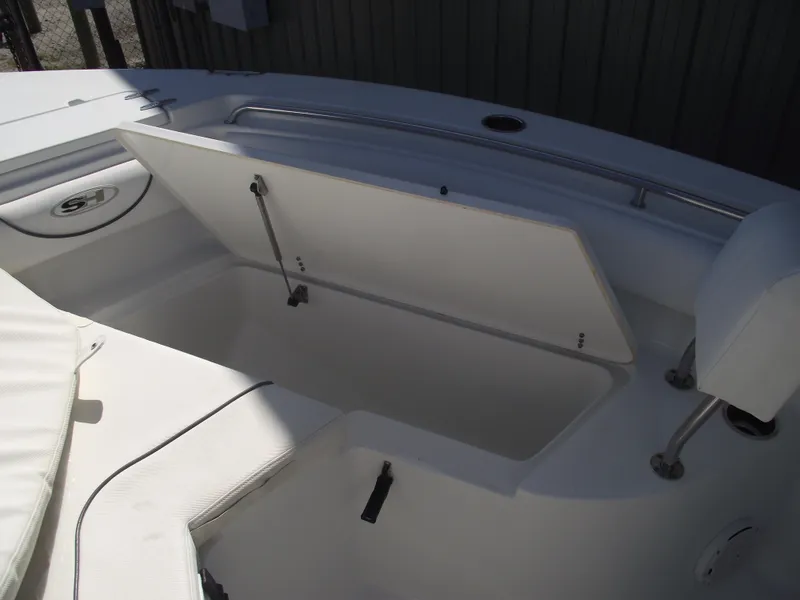 Slide: The Image of 2017 Sea Hunt Ultra 211 boat storage compartment open, showcasing interior space. - 11