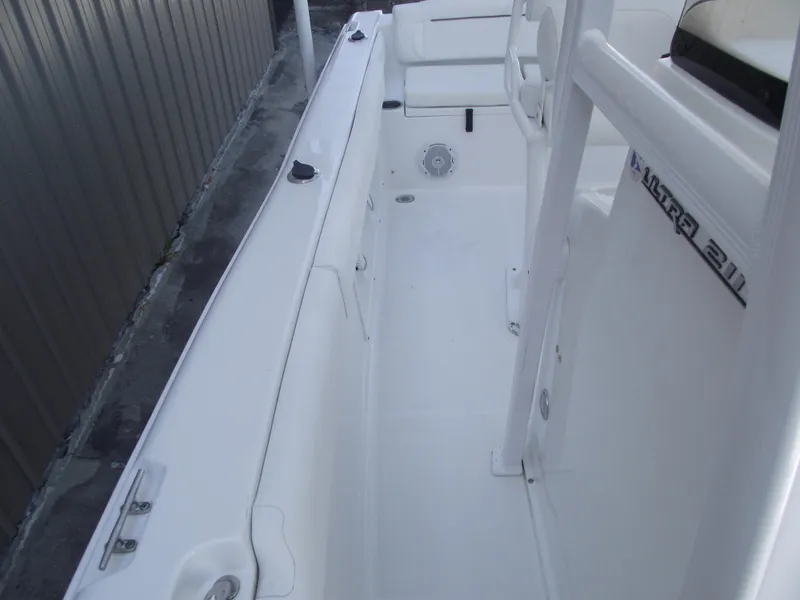 Slide: The Image of 2017 Sea Hunt Ultra 211 boat interior, featuring white seating and sleek design. - 12